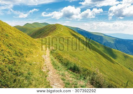 Traverse Path Through Mountain Range. Beautiful Summer Landscape At High Noon. Green Grassy Alpine H