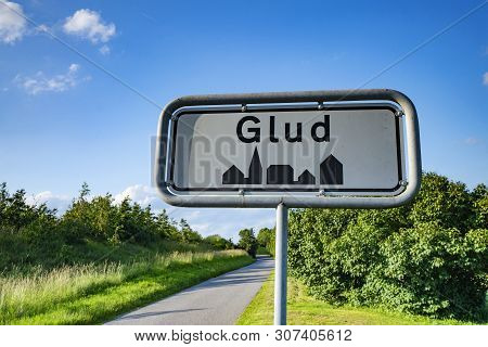 Glud City Sign In A Small Town In Denmark Under A Blue Sky In The Summer By A Trail