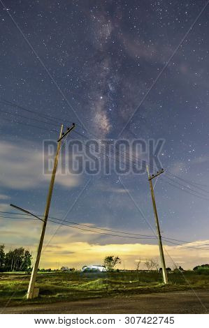 Electric Poles In The Nighttime Countryside, The Sky With Stars And Beautiful Taro Scenes, Clouds Be