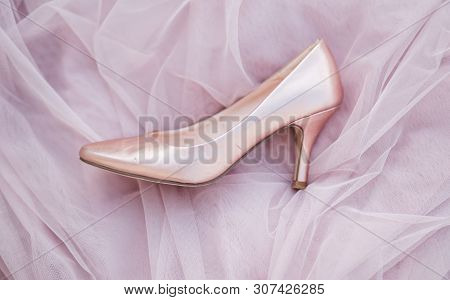 Pink Gold Bridal Shoes. Tender Beige Fatin Cloth Texture Background. Top View Of Ladys Pumps. Space 