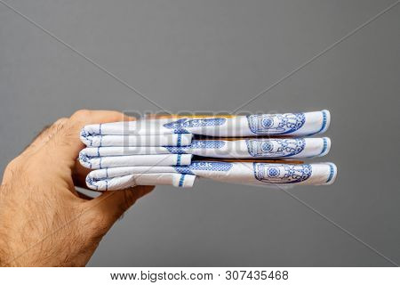 Paris, France - May 16, 2019: Man Hand Holding Against Gray Background Stack With New Swirl Vacuum C