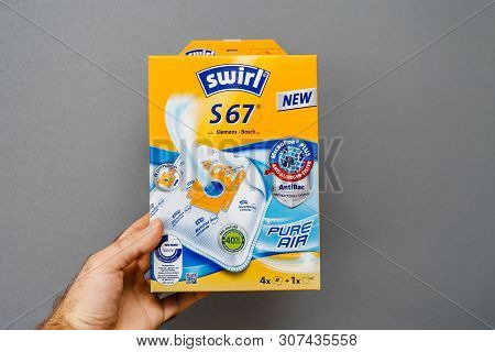 Paris, France - May 16, 2019: Man Hand Holding Against Gray Background Pack With New Swirl Vacuum Cl