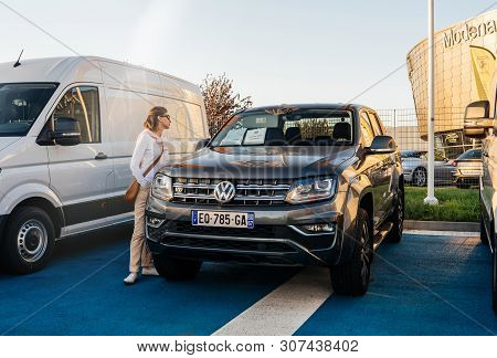 Strasbourg, France - Oct 15, 2017: Young Woman Buy Looking At The Special Offer At The Car Dealershi