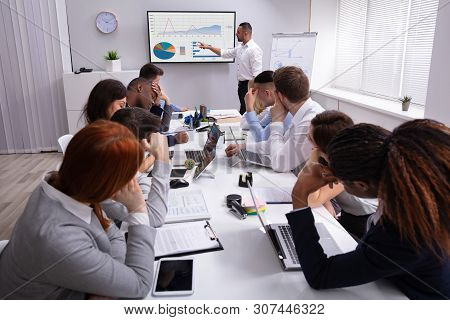 Group Of Business Executives Tired Of Long Meeting In Office