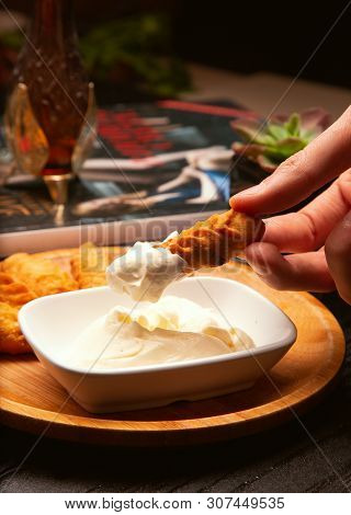 Dipping Traditional Caucasian Dushbere, Gurze Into Yogurt Sauce. Image