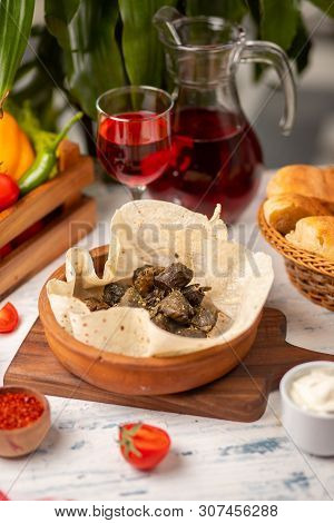 Green Grape Leaves Stuffed With Meat, Rice, Herbs, Onion And Cooked In Olive Oil, Served With Lavash