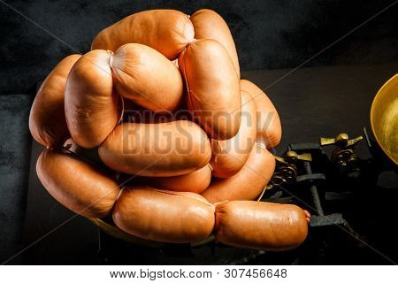 Closeup Set Of Short Thick Wieners Rolled In Spiral On Scales