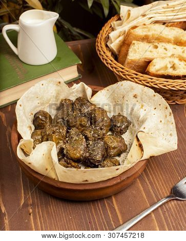 Green Grape Leaves Stuffed With Meat, Rice, Herbs, Onion And Cooked In Olive Oil, Served With Lavash