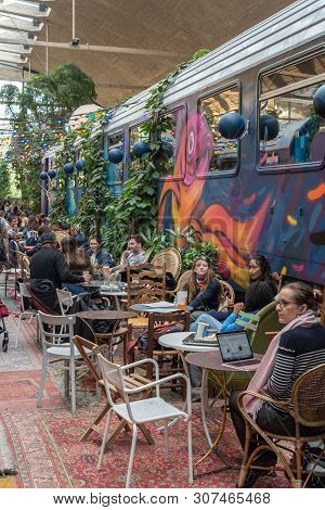 Paris, France - April 15, 2019 : People Near A Decorated Train Car In La Felicita Italian Bar-restau