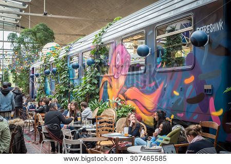 Paris, France - April 15, 2019 : People Near A Decorated Train Car In La Felicita Italian Bar-restau