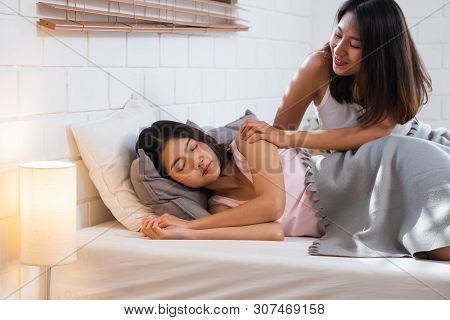 Happy Lesbian Couple Wake Up On Bed In Bedroom In Morning And Hug Each Other At Home.lgbtq Lifestyle