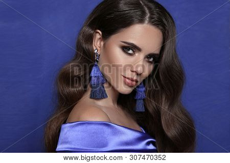 Beautiful Brunette With Tassel Earrings Over Blue. Jewelry Bijouterie Fashion. Sensual Woman With Sh