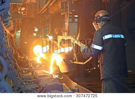 Workers At A Metallurgical Plant Pour Hot Metal, Cast Iron, Copper In The Form Of Products.