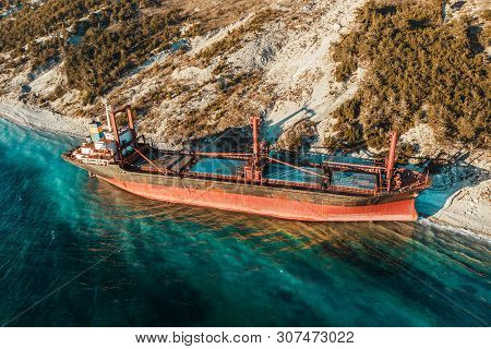 Aerial View Of Ship Run Aground On Sea Coast, Shipwreck After Storm, Drone Photo