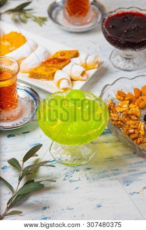 Tea Set With Varieties Of Traditional Nuts, Lemon, Confiture And Sweets Served On White Tablecloth -