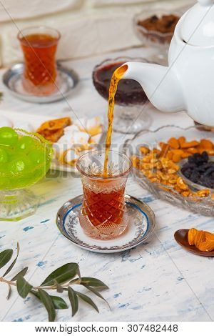 Tea Set With Varieties Of Traditional Nuts, Lemon, Confiture And Sweets Served On White Tablecloth -
