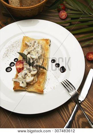 Mushtoom Sauteed, Chicken Stroganoff On A Piece Of Bread. Antipasta In A Decorated White Plate With 