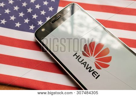 Maski, India - June 21, 2019: Huawei Logo On Screen Of Mobile On Us Flag.
