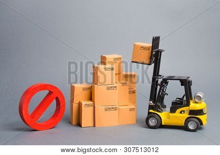 Yellow Forklift Truck Truckraises A Box Over A Stack Of Boxes And A Red Symbol No. Embargo Trade War