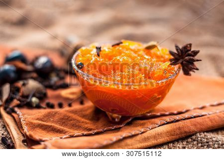 Famous Indian Dessert And Sweet Dish In A Glass Bowl On Jute Bag's Surface I.e. Murabba Or Murba Alo