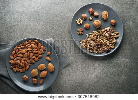 Assortment Of Nuts In Plate. Hazelnuts, Walnuts And Almonds