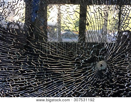 On The Windshield Of My Car Trail From A Bullet Or A Stone, Which Threw The Many Cracks Propagating 