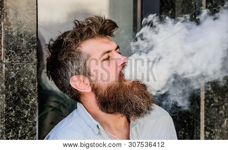 Smoking Electronic Cigarette. Stress Relief Concept. Smoking Device. Man Long Beard Relaxed With Smo