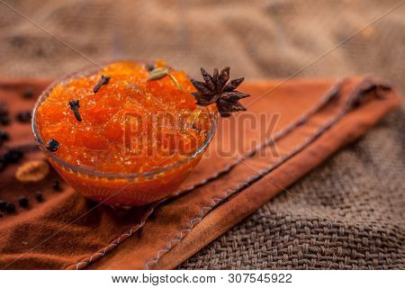 Famous Indian Dessert And Sweet Dish In A Glass Bowl On Jute Bag's Surface I.e. Murabba Or Murba Alo