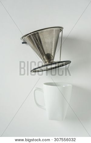 White Coffee Mug On White Background With Filterless Metal Pour Over Drip Cone