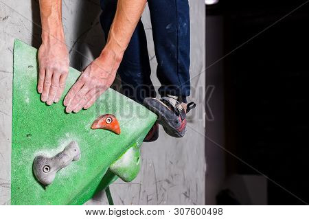 Rocky Shoe On A Tiny, Scanty Snare Stands With The Tip Of The Sock In Close-up On The Climbing Wall 