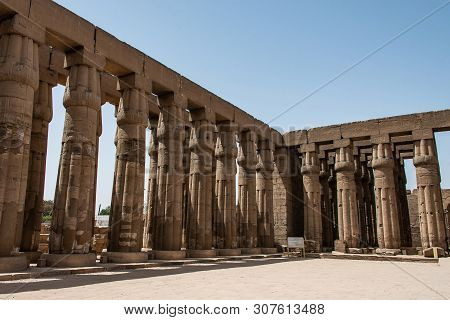 Ancient Sculptures And Columns Hieroglyphs And Relief Engravings Carved Into A Stone Wall At Luxor T