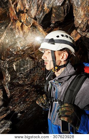 Young Speleologist Is Exploring A Dark Cave