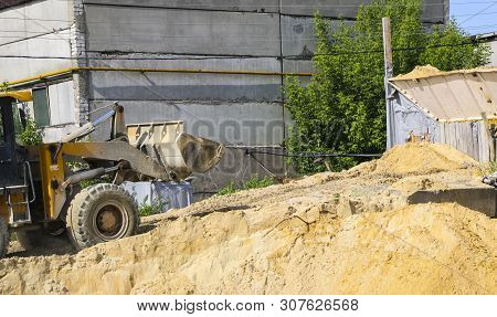 Tractor Collects Scoop With  Gravel. Excavator Extracts Sand And Gravel For  Concrete Mix.