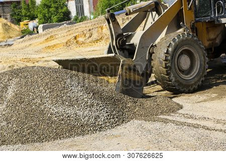 Tractor Collects Scoop With  Gravel. Excavator Extracts Sand And Gravel For  Concrete Mix.
