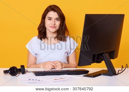 Close Up Portrait Of Beautiful Young Brunette Female Sitting At White Desk In Front Of Computer At H
