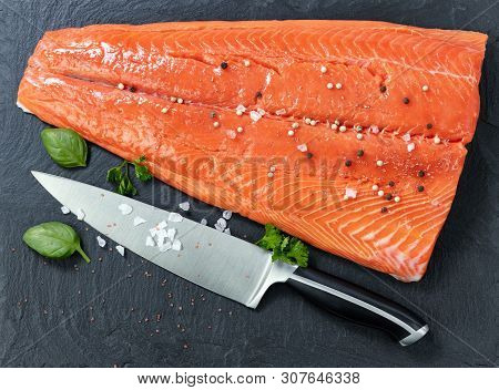Fresh Raw King Salmon On Natural Stone With Herbs And Seasoning