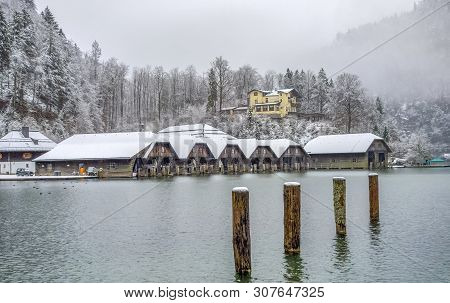 Snowbound Scenery Including Some Boathouses Around Schoenau Am Koenigssee In Bavaria At Winter Time