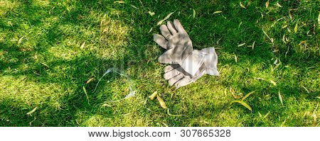 Protective Gloves And Glases Laying On Green Grass During Hot Summer Day, From Above