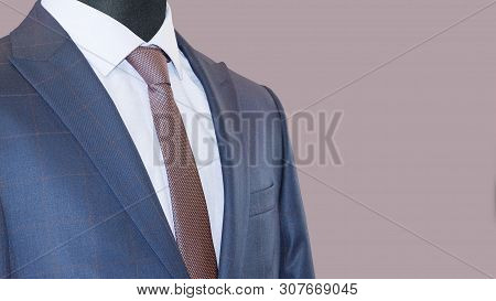 Mens Suit: Jacket, Shirt & Tie Isolated On A Mauve Background. Business Style. Elegant Clothes. Men 