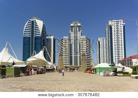 Square In The Flower Park In Front Of The Complex Of Tall Buildings Of Grozny City In The City Cente