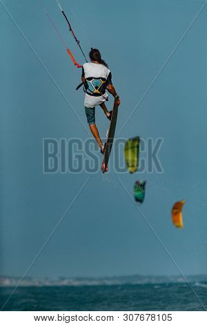 Kitesurfing on the waves of the sea in Mui Ne beach, Phan Thiet, Binh Thuan, Vietnam. Kitesurfing, Kiteboarding action photos Kitesurfer In action