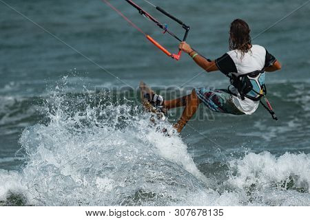 Kitesurfing on the waves of the sea in Mui Ne beach, Phan Thiet, Binh Thuan, Vietnam. Kitesurfing, Kiteboarding action photosKitesurfer In Action