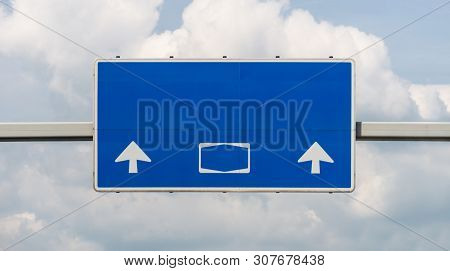 A Large Road Sign Above A German Highway In Blue, With No Signs And Subtitles, With A Clipping Path.