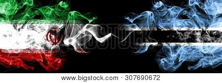Iran Vs Botswana, Botswanan Smoky Mystic States Flags Placed Side By Side. Thick Colored Silky Smoke