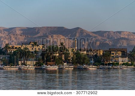Luxor, Egypt 17.05.2018 View Of The Nile River West Bank Town Coastline With Sailboats In Luxor, Egy