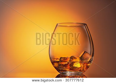Glass Of Scotch Whiskey And Ice On A White Background