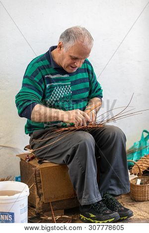 Camacha, Madeira, Portugal - April 19, 2018: A Basket Weaver At Work In The Factory Shop In Camacha 