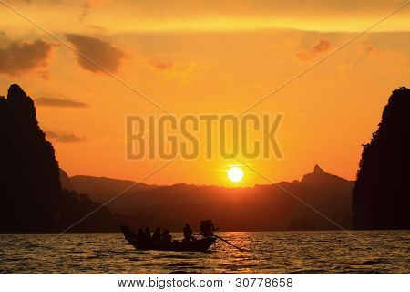 Boat looking sunset on lake