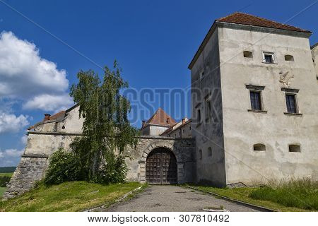 Ancient Historical Fortified Svirz ( Svirzh ) Castle At A Summer Day Against The Blue Sky And White 