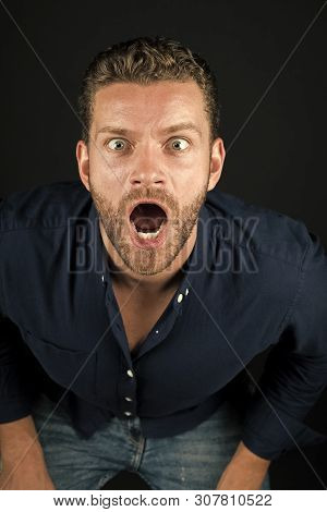 Man With Open Mouth On Bearded Face Leaning Forward On Dark Background. Macho Wearing Fashionable Bl